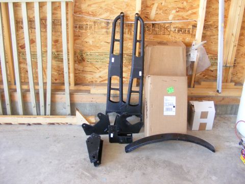 1995 Ford F-150 - Various truck lift kit components are organized on the floor, ready for installation.
