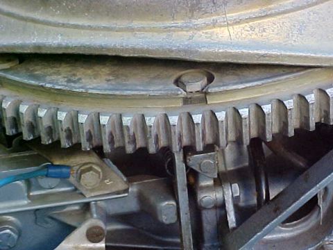 1987 Ford Bronco - A close-up view of engine components, including a toothed gear and wiring, is shown.