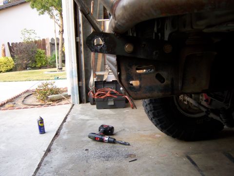 1991 Ford Bronco - Photograph of a truck undercarriage and frame with a toolbox and drill on the driveway.