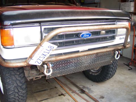 1991 Ford Bronco - Photograph of a Ford truck front end fitted with a custom tubular bumper and grille guard.