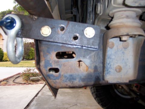1991 Ford Bronco - Photograph of a custom welded bumper mount bracket bolted onto a truck frame rail.