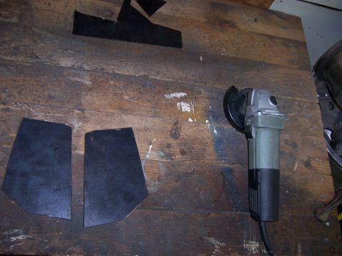 1991 Ford Bronco - Angle grinder and metal pieces on a workbench, likely for fabrication.