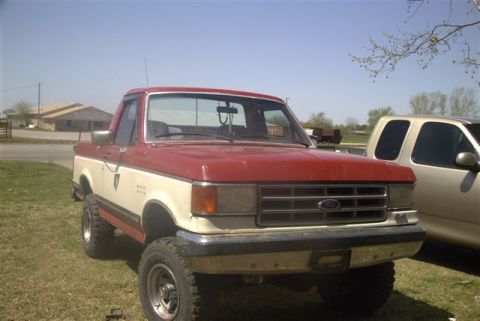 1987 Ford Bronco - This two-tone Ford F-Series truck appears to be from the late 1980s, with a prominent grille and raised suspension.