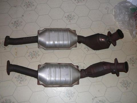 1997 Mercury Grand Marquis - Two exhaust catalytic converters are shown side-by-side on a patterned floor.