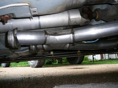 1997 Mercury Grand Marquis - Custom exhaust modification showing the Y-pipe and driveshaft connection.