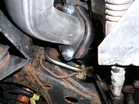 1997 Mercury Grand Marquis - Close-up view of a vehicle's exhaust pipe connection, showing bolts and flange.