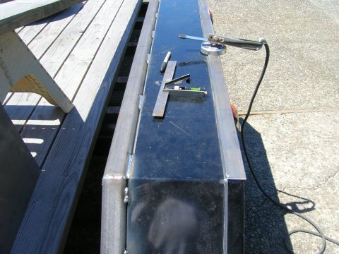 1996 Ford Bronco - Welding equipment and tools are placed on a trailer frame, suggesting ongoing construction or repair work.
