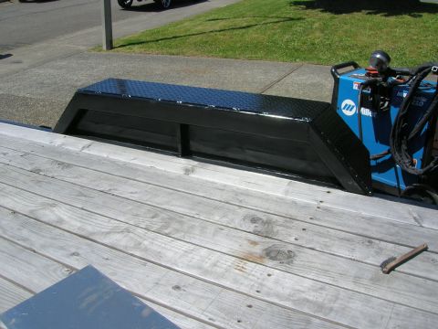 1996 Ford Bronco - A black diamond plate toolbox and a blue Miller welding machine sit on a wooden trailer deck.
