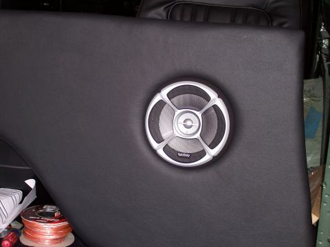 1978 Ford Bronco - An Infinity speaker is mounted on a black interior panel, with speaker wire and other items nearby.