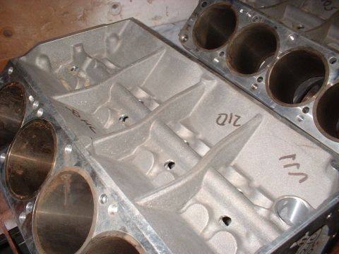 1970 Ford Mustang - Close-up of two engine blocks, showing cylinder bores and cast-in markings.