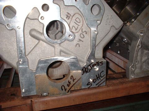 1965 Shelby Cobra - A close-up view of an engine block part with handwritten markings and part numbers visible.