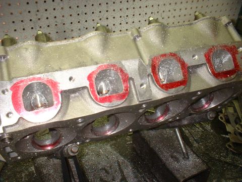 1965 Shelby Cobra - This engine part shows intake ports prepared for assembly, with red sealant visible around the openings.