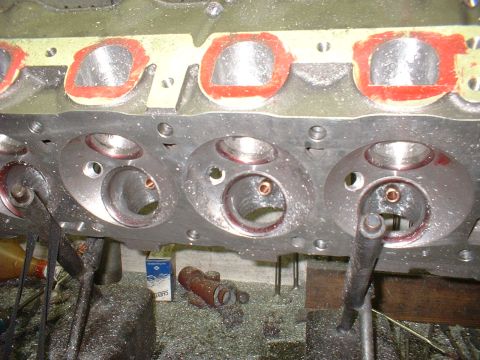 1965 Shelby Cobra - Close-up of an engine cylinder head, showing machined ports and surrounding debris.