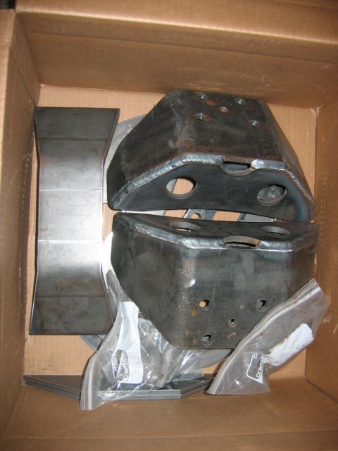 1992 Ford Mustang - Unidentified metal automotive parts are neatly arranged inside a cardboard box.