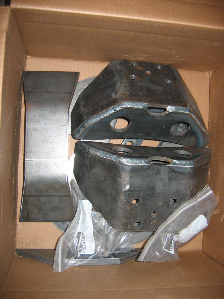 Metal brackets and plates inside a cardboard box