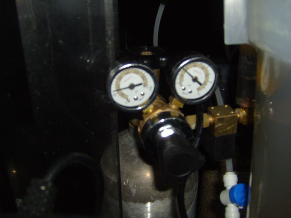 Pressure regulator with two gauges, one showing approximately 50 psi and the other approximately 100 psi. Part of a larger system