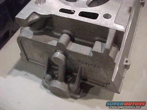 1970 Ford Mustang - Close-up view of a metal engine block part, showing casting details and texture.