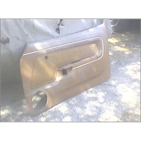 1973 Ford Ranchero - This is a tan door panel with a speaker cutout, likely from an older vehicle.