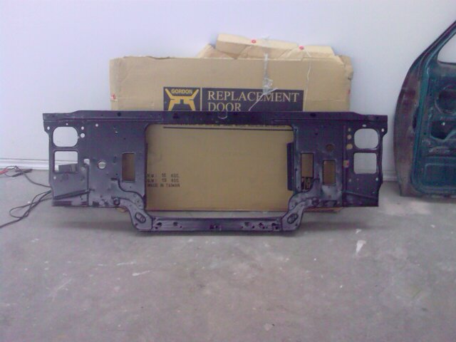 Radiator support with "REPLACEMENT DOOR" box behind it