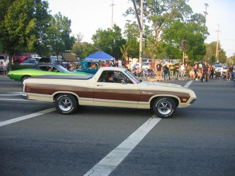 1970 Ford Ranchero - A 1970 Ford Ranchero with distinctive woodgrain trim is seen driving on a street, with another vehicle behind it.