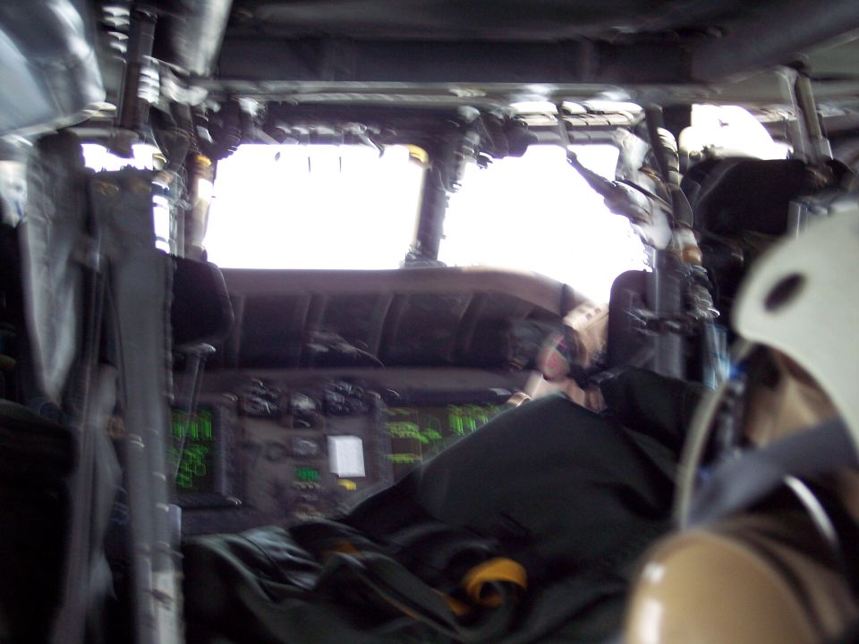Interior view of a vehicle's dashboard with green digital displays and white paper