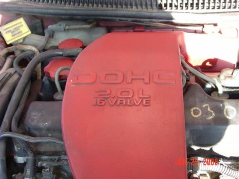 1997 Dodge Neon - Close-up of an engine bay showing a red DOHC 2.0L 16 valve cover.