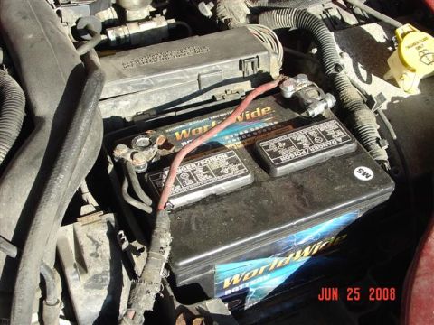 1997 Dodge Neon - Close-up of a car battery and surrounding engine components, dated June 25, 2008.