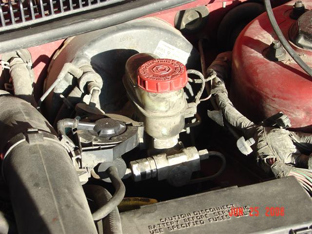 Close-up of car's brake fluid reservoir and master cylinder