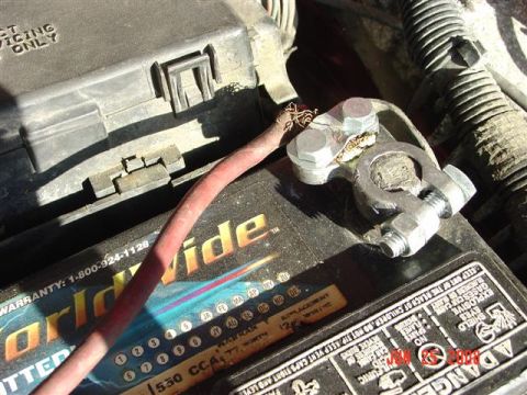 1997 Dodge Neon - Close-up of a car battery and its associated wiring and fuse box.