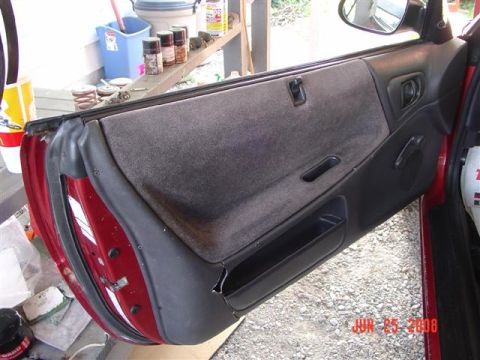 1997 Dodge Neon - Close-up of a car's interior door panel, with visible text at the bottom right.