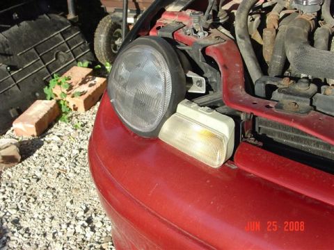 1997 Dodge Neon - Close-up of a red car's front corner, showing the headlight and turn signal assembly. A watermark indicates the photo was taken on June 25,…