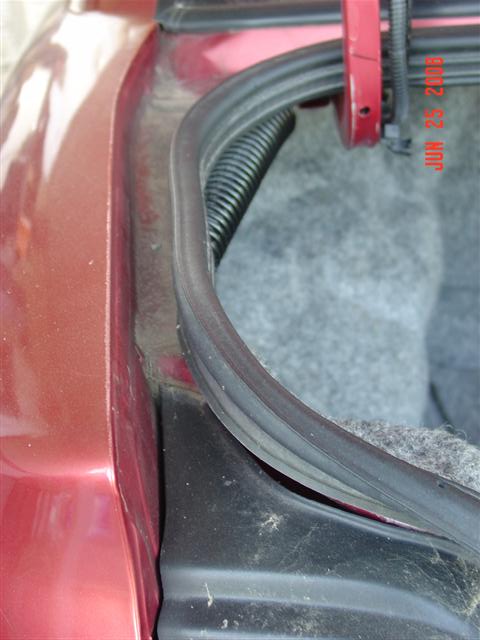 1997 Dodge Neon - A close-up view of the trunk seal and carpet in a vehicle, with a date stamp visible.