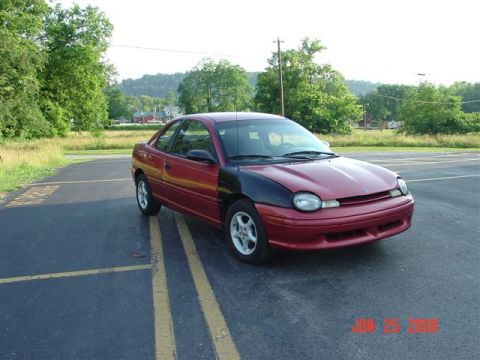 1997 Dodge Neon - This 1997 Dodge Neon coupe has a red body and a black hood, parked outdoors.