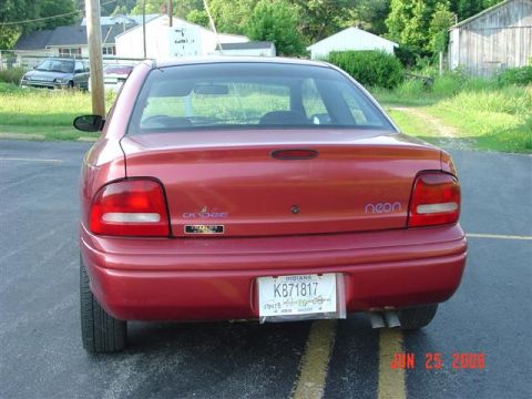 1997 Dodge Neon - Red 1997 Dodge Neon sedan parked outdoors, showing the rear and license plate.