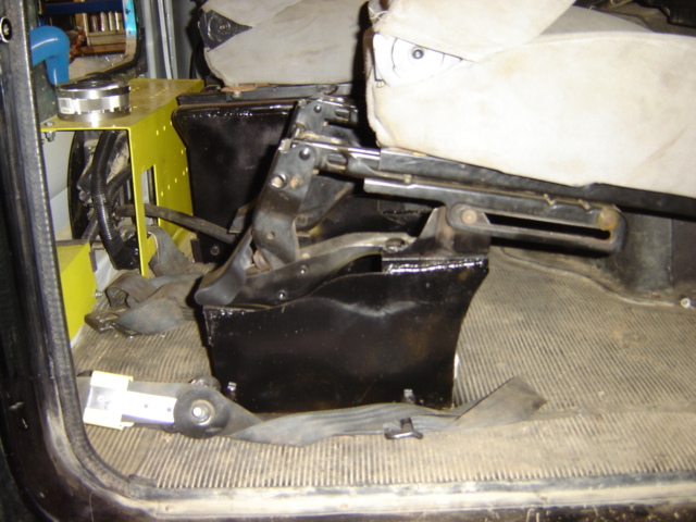 Interior view of seat mounting hardware and floor mat