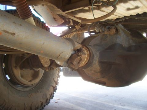 1994 Ford F-150 - Underside view of a truck's rear axle and driveshaft, highlighting mechanical components and signs of age.