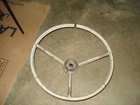 1967 Ford F-250 - A vintage steering wheel, likely from an older vehicle, is shown up close.