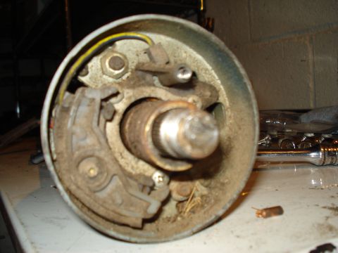 1967 Ford F-250 - A disassembled steering column part sits on a workbench, showing internal components and wiring.