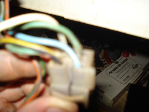 1967 Ford F-250 - Wiring harness connector with colored wires, with a pilot bearing puller attachment box in the background.