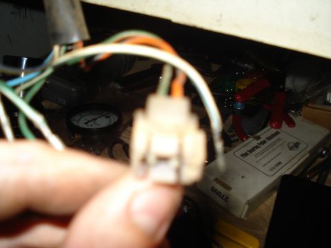1967 Ford F-250 - An electrical connector and a gauge are visible in this close-up shot, likely related to vehicle maintenance.