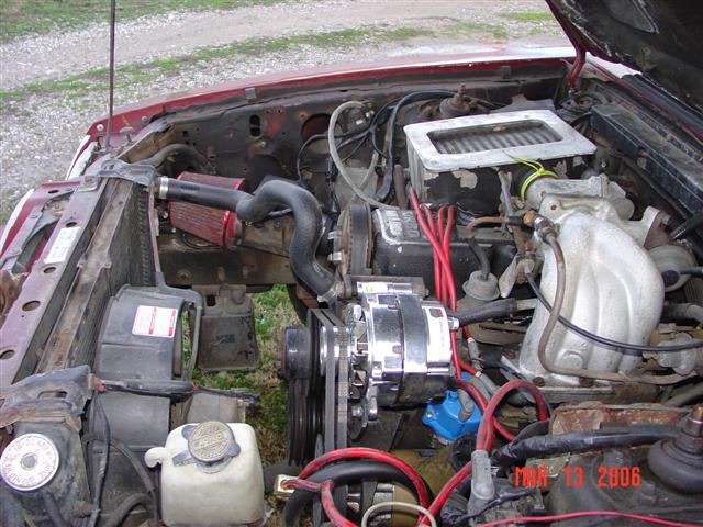 engine bay with aftermarket air intake and chrome alternator