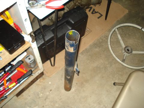 1967 Ford F-250 - A blue metal tube, possibly a steering column part, sits on the floor next to tools and a steering wheel.