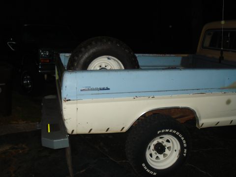 1967 Ford F-250 - Rear view of a 1967 Ford F-250 Ranger showing the bed with a spare tire and another vehicle in the background.