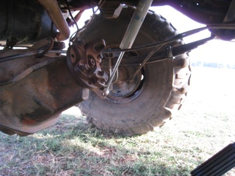 1996 Ford Bronco - Close-up view of the rear axle and suspension system on a truck, highlighting its heavy-duty components.