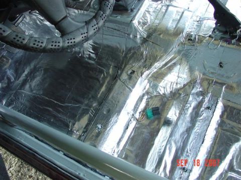 1984 Ford Mustang - Sound deadening material installed on the floor of a car interior.