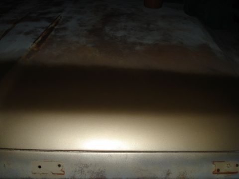 1967 Ford F-250 - This image shows a close-up of a metal panel, likely a vehicle part, with signs of rust and wear.