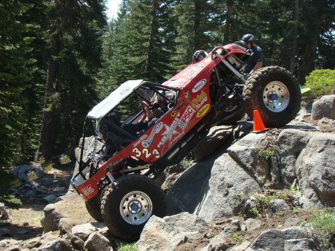 1989 Ford Bronco - A heavily modified off-road vehicle navigates a challenging rocky terrain.