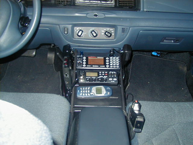 Police vehicle center console with Uniden radios, scanner and cell phone