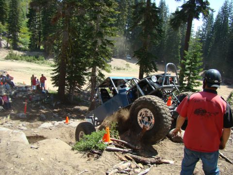 1989 Ford Bronco - People gathered around a tractor in a sunny, wooded outdoor setting.