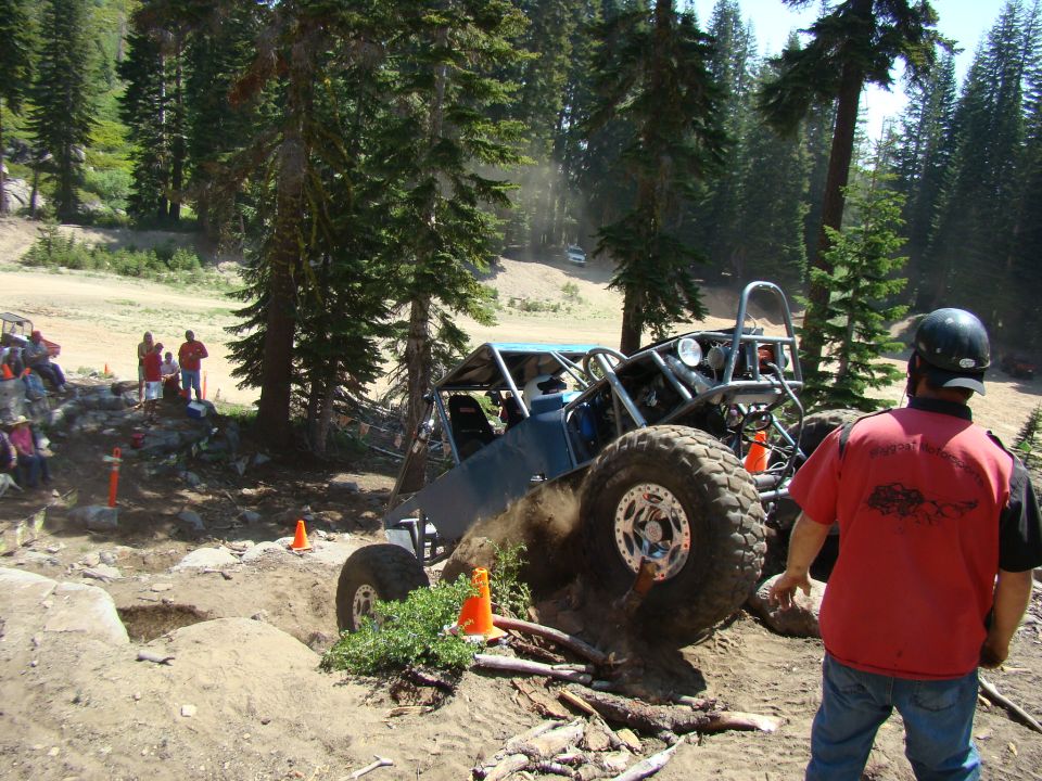 Tractor with people around it in a wooded area